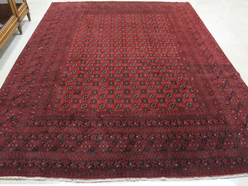 Appraisal: HAND KNOTTED AFGHAN MAURI CARPET featuring a field of Turkoman