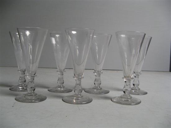 Appraisal: Set of seven th century clear glass flutes knopped inverted