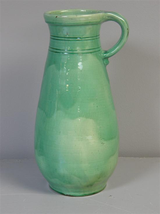 Appraisal: Green glazed pottery vase with loop handle signed on base