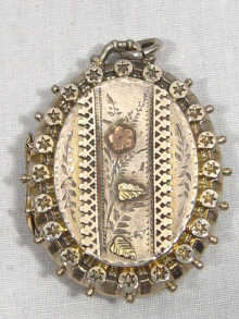 Appraisal: A Victorian silver locket with applied two colour gold floral