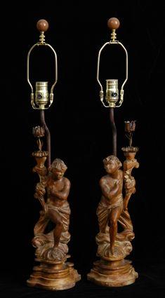 Appraisal: PAIR OF BAROQUE-STYLE CARVED WOOD FIGURAL PRICKET STICKS MOUNTED ON