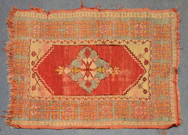 Appraisal: AN OLD TURKISH RUG with central red ground medallion within