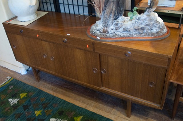 Appraisal: WONDER WEDGE TEAK SLIDING DOOR THREE DRAWER SIDEBOARD