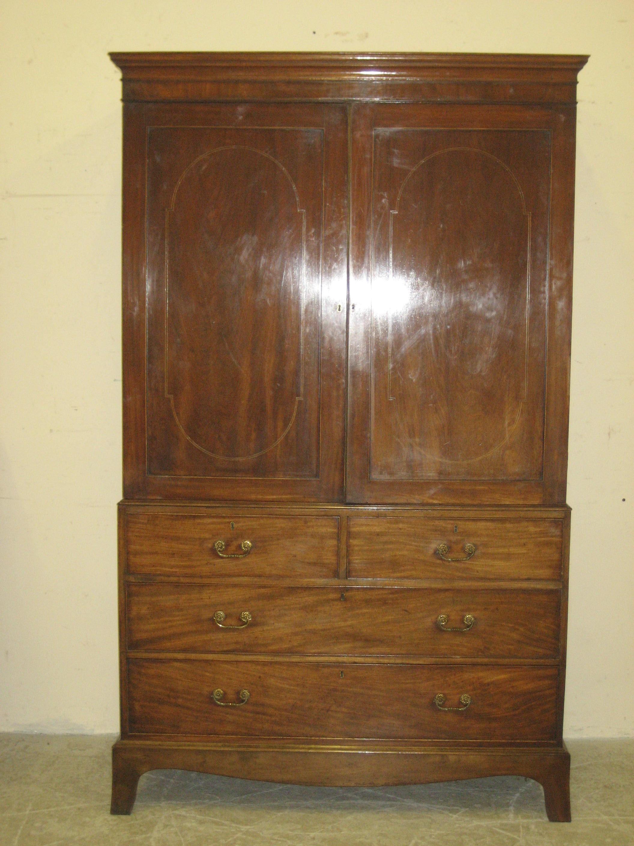 Appraisal: A MAHOGANY LINEN PRESS early th century the cavetto cornice