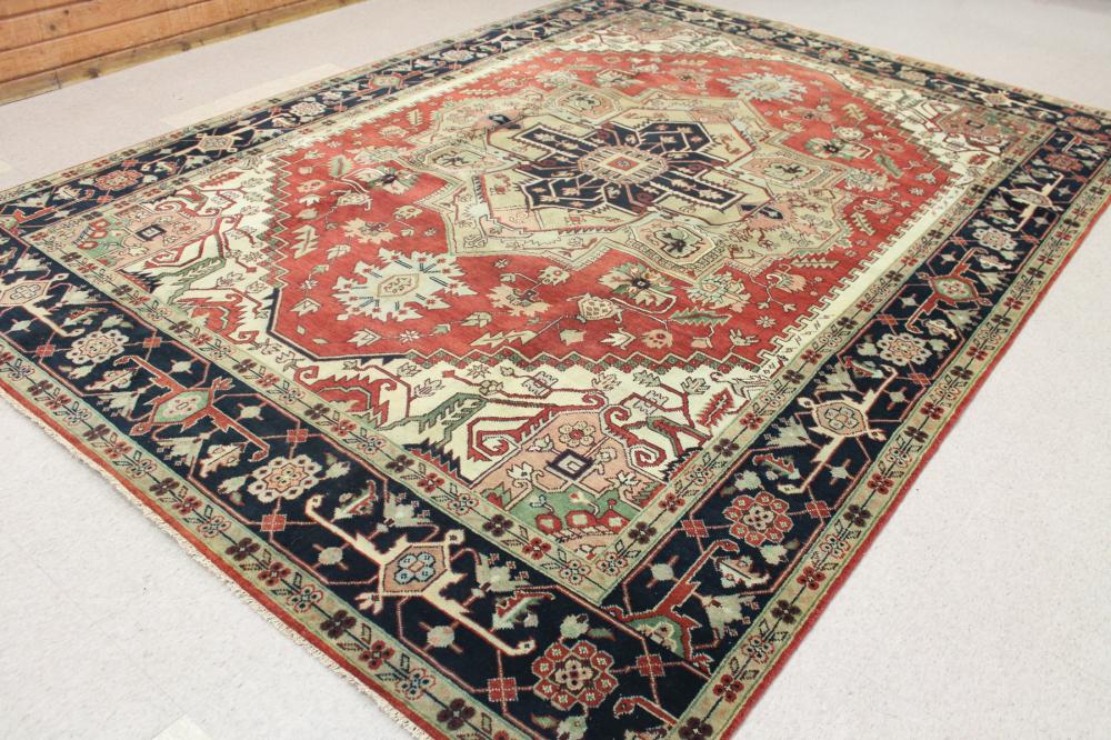 Appraisal: HAND KNOTTED ORIENTAL CARPET Indo-Serapi central geometric medallion and stylized