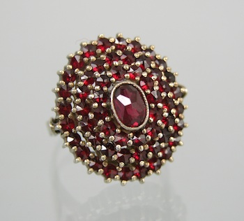 Appraisal: A Vintage Czech Garnet Ring in Silver Four-tiered mount features