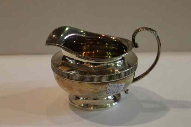 Appraisal: A SILVER CREAM JUG of circular form with pedestal foot