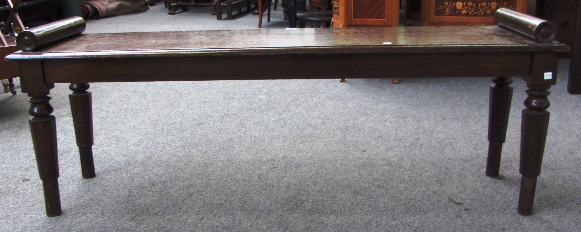 Appraisal: A Victorian oak hall bench with turned end stops on