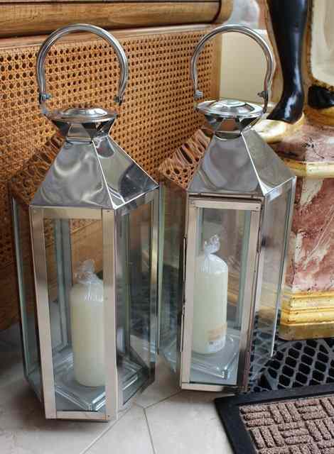 Appraisal: A PAIR OF SILVERED HEXAGONAL CANDLE LANTERNS with loop handles