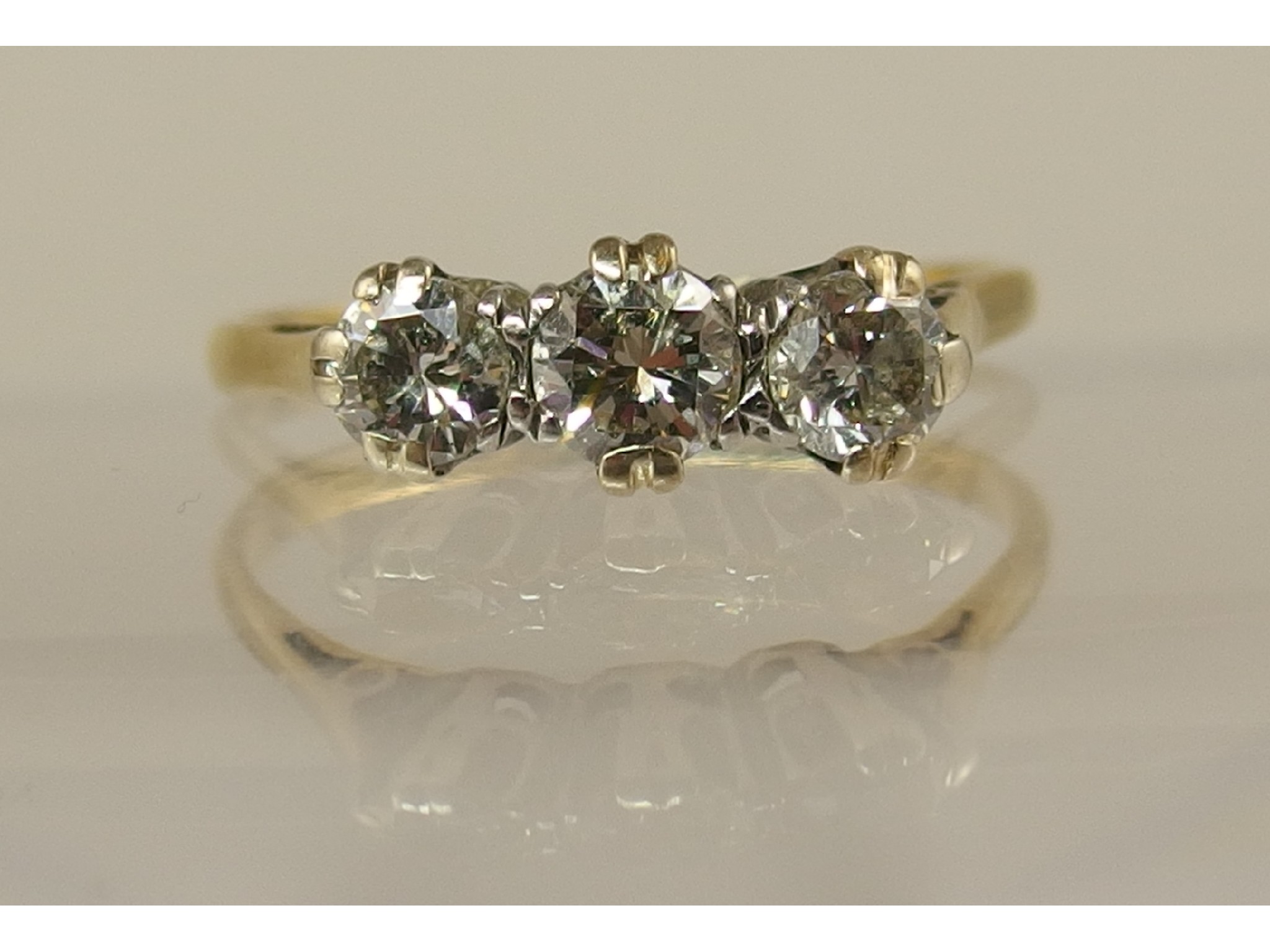 Appraisal: A platinum and yellow metal three stone diamond ring of