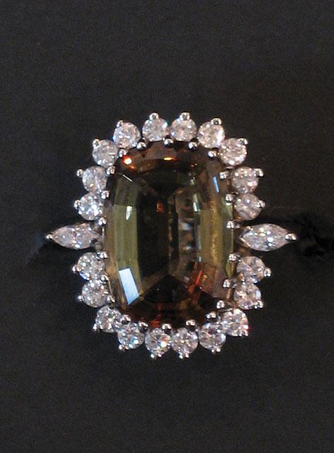 Appraisal: AN ANDALUSITE AND DIAMOND DRESS RING the central cushion-cut Andalusite