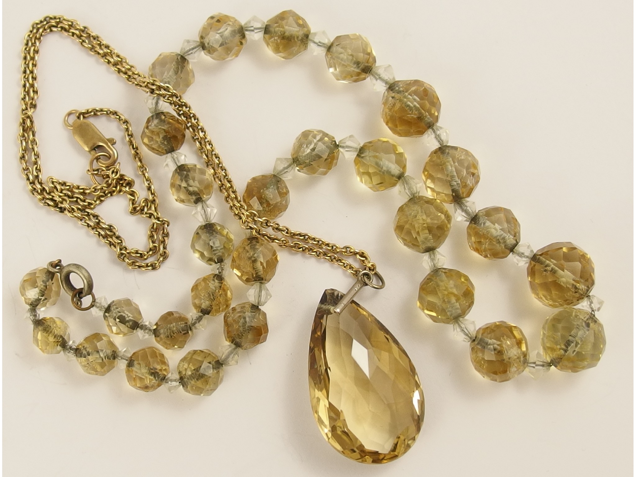 Appraisal: A string of facet cut citrine quartz beads and a