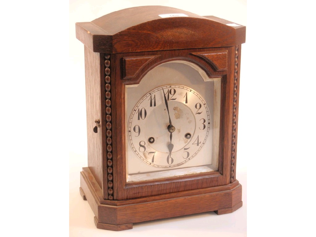 Appraisal: A 's oak mantel clock with eight day Junghans movement