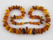 Appraisal: A graduated amber necklace largest piece approx mm wide necklace