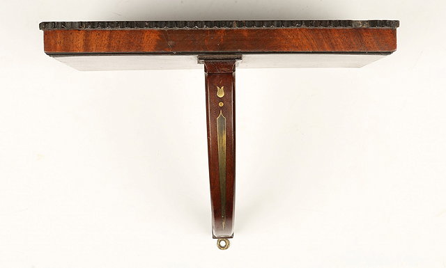 Appraisal: A REGENCY MAHOGANY AND BRASS INLAID CLOCK BRACKET with shaped