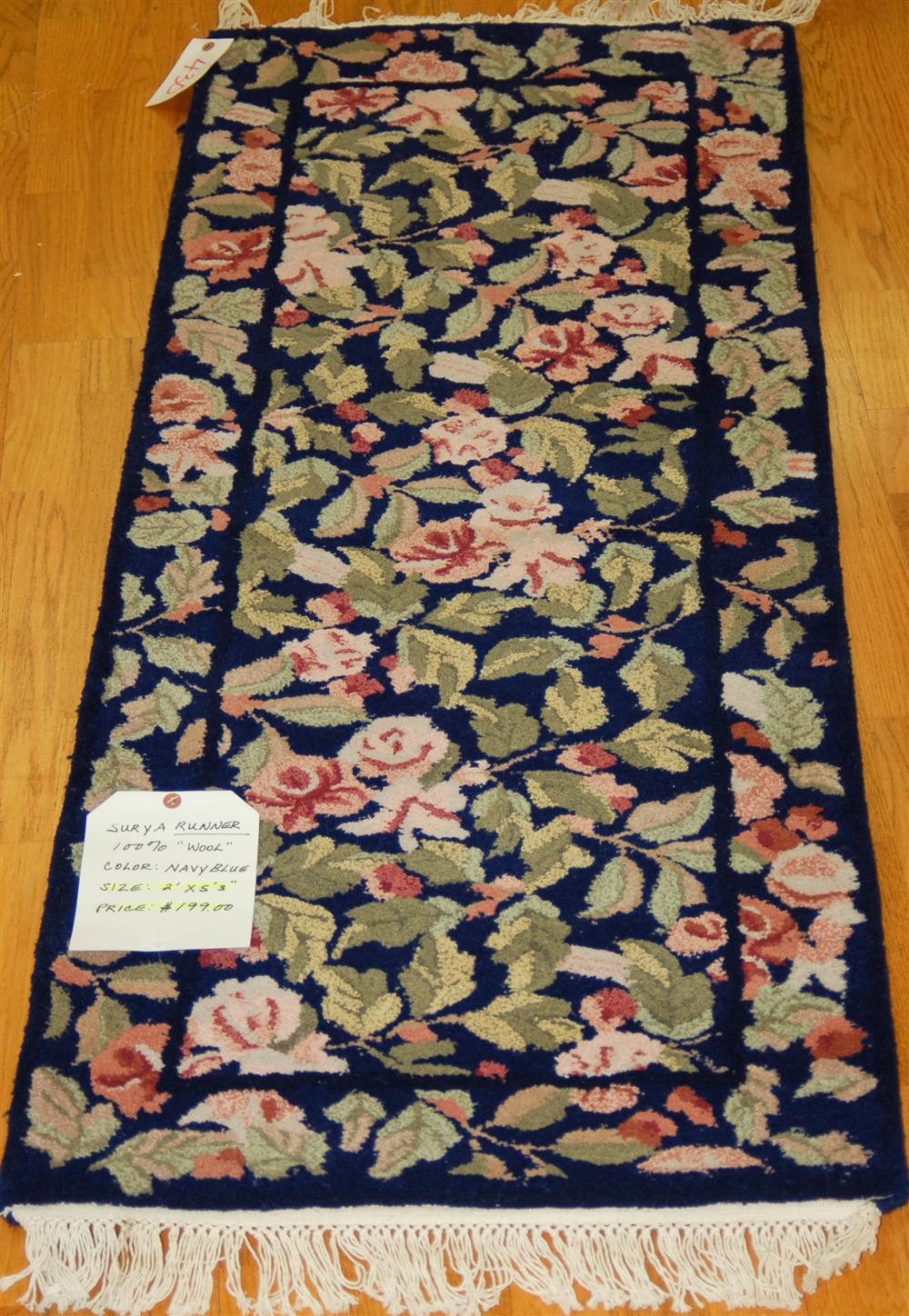 Appraisal: LOOMED WOOL RUNNER consisting of a blue field with leaves