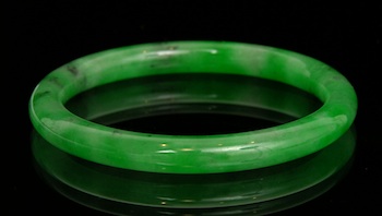 Appraisal: Carved Jadeite Bangle Bracelet Very well carved translucent jadeite tubular