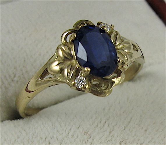 Appraisal: SAPPHIRE DIAMOND AND K GOLD RING set with an oval-cut