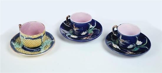 Appraisal: THREE MAJOLICA CUPS AND SAUCERS English nd half- th century