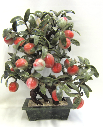 Appraisal: CHINESE HARDSTONE FRUITING JADE TREE having peaches and leaves on