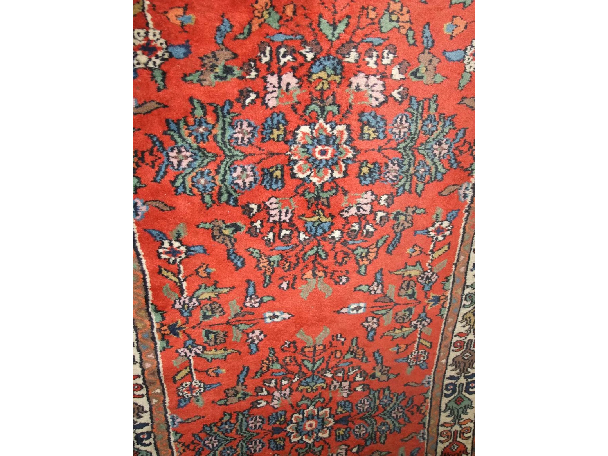 Appraisal: A Persian style runner with red ground field within cream