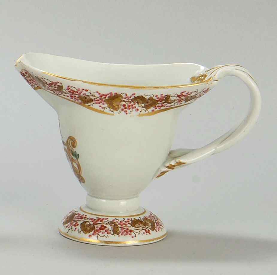 Appraisal: ENGLISH CHINESE EXPORT-STYLE PORCELAIN HELMET-FORM CREAMER th CenturyDecorated with the