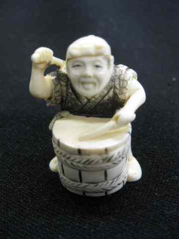 Appraisal: Carved Ivory Netsuke of Man Playing Drum fine polychrome details