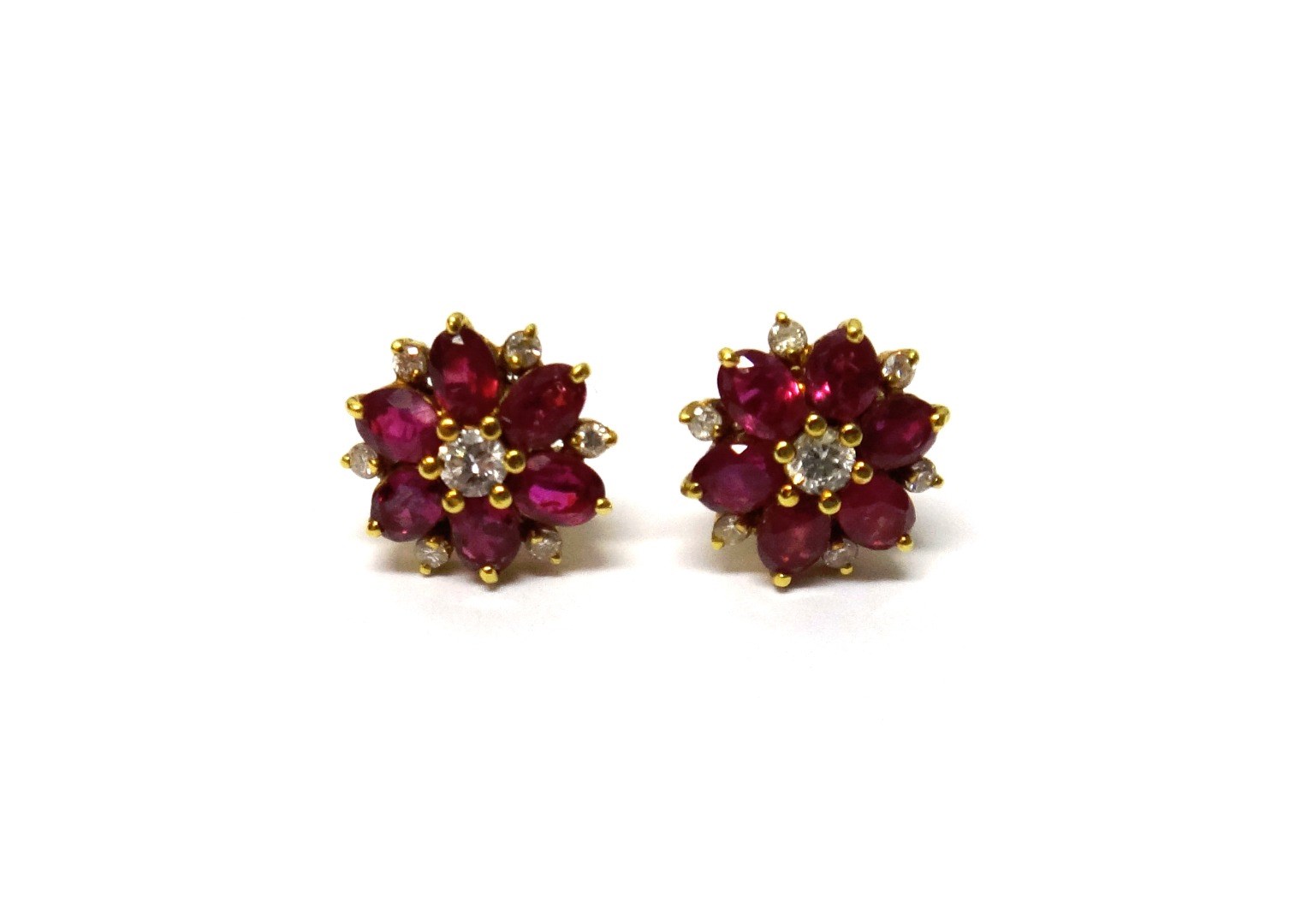 Appraisal: A pair of gold diamond and ruby set cluster earstuds