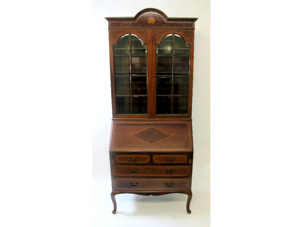 Appraisal: An Edwardian mahogany inlaid bureau bookcase the arched top raised