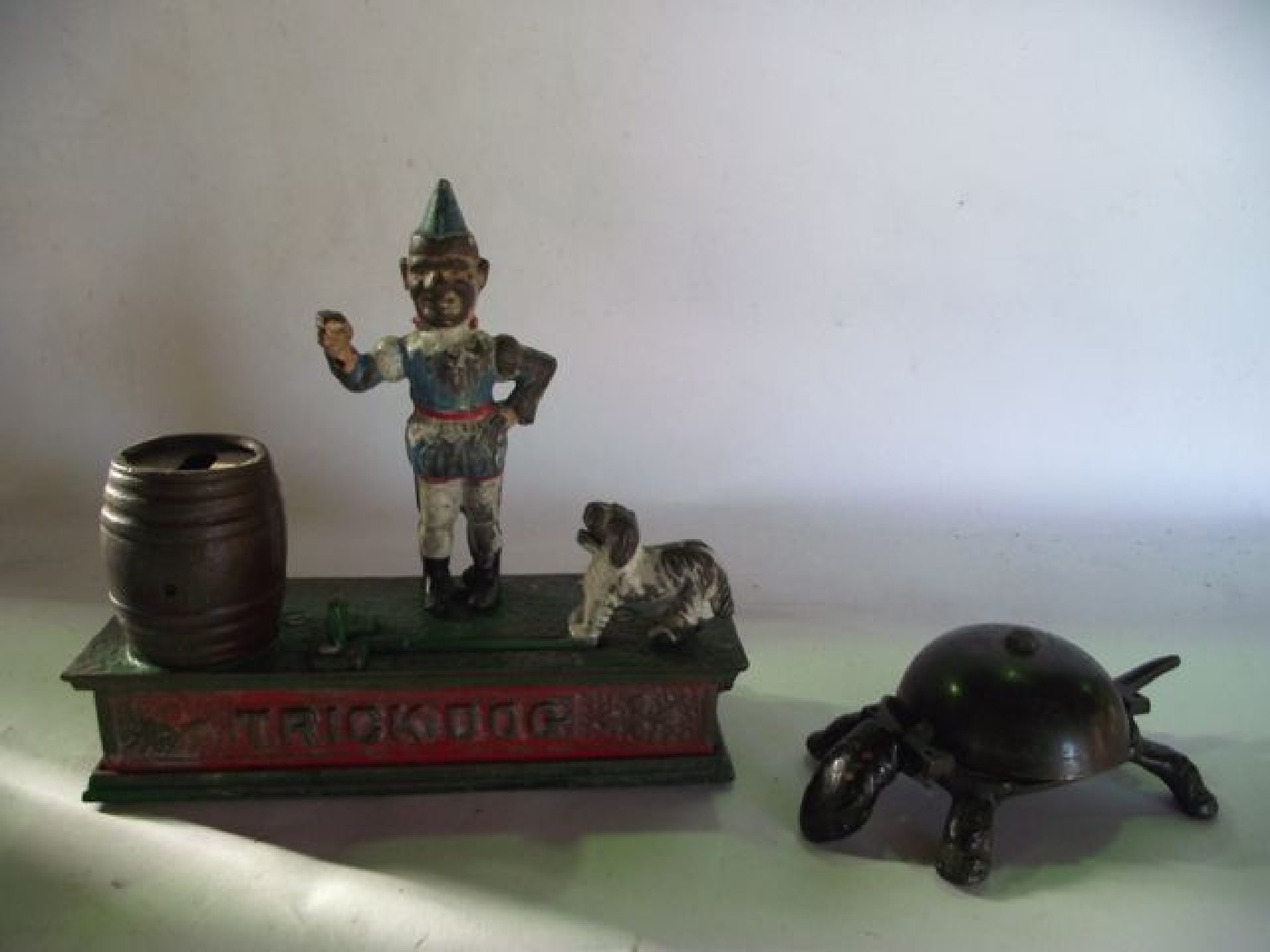 Appraisal: A vintage novelty money box with a spring loaded dog