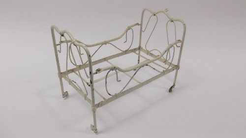 Appraisal: A dolls' cream painted bedstead with wire scrollwork and the