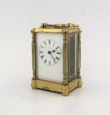 Appraisal: A brass framed carriage timepiece day movement with swing handle