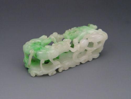 Appraisal: CHINESE JADEITE SLIDE Highly articulated with mythological beasts and clouds