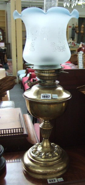 Appraisal: A Victorian brass oil lamp with etched glass shade and