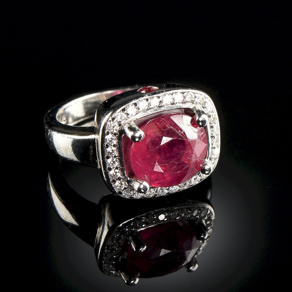 Appraisal: A K WHITE GOLD RUBY AND DIAMOND HALO LADY'S RING