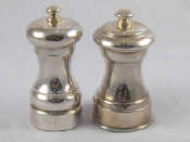 Appraisal: Two silver capstan shaped pepper mills London and Birmingham