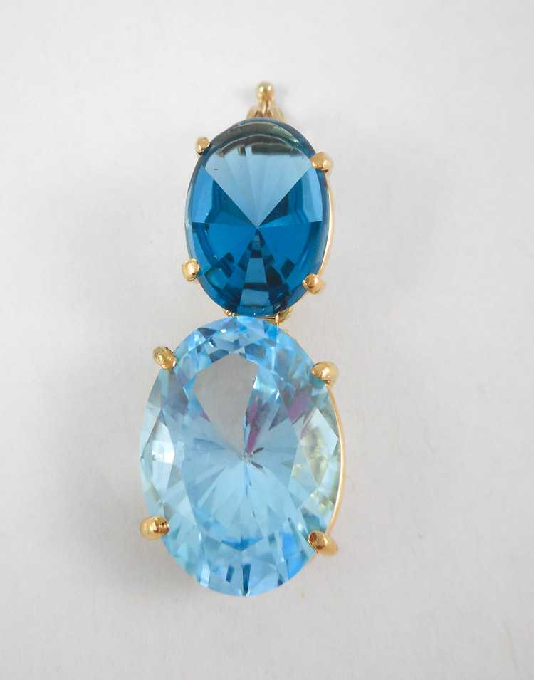 Appraisal: BLUE TOPAZ AND FOURTEEN KARAT GOLD PENDANT set with an