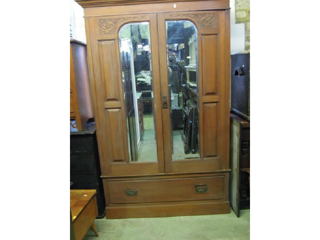 Appraisal: An Edwardian walnut wardrobe enclosed by a pair of bevelled