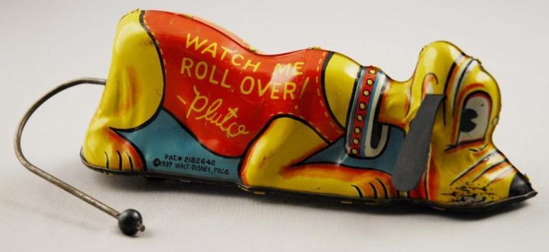 Appraisal: Marx Tin Walt Disney Pluto Rollover Toy Description Marked Walt