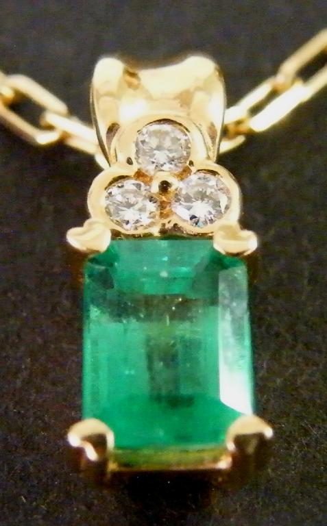 Appraisal: k emerald and diamond pendant on a slender en suite