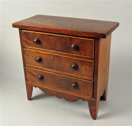 Appraisal: Miniature English mahogany and satinwood chest of drawers The rectangular