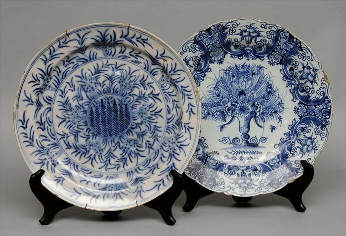 Appraisal: TWO DELFT BLUE AND WHITE CHARGERS One with flower-filled vase