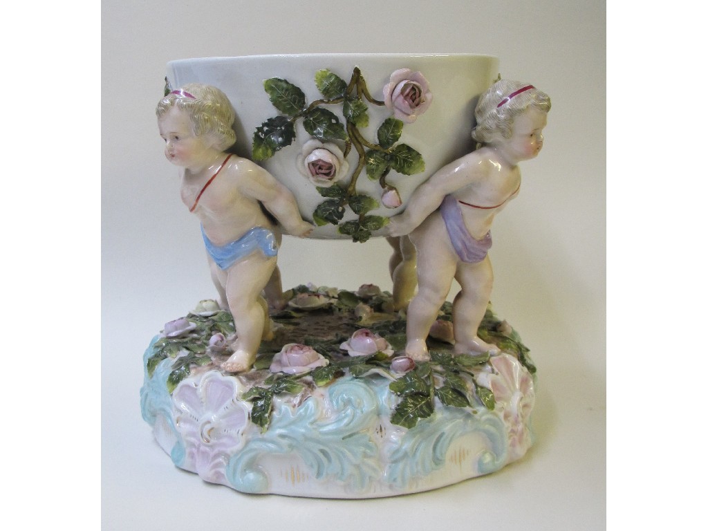 Appraisal: A Sitzendorf comport modelled with four cherubs modelled with four