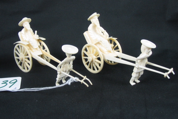 Appraisal: TWO CHINESE CARVED IVORY RICKSHAWS the larger of a scholarly