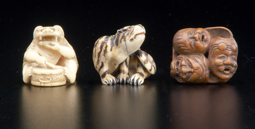 Appraisal: JAPANESE NETSUKE Carved and stained ivory tiger natural himotoshi formed