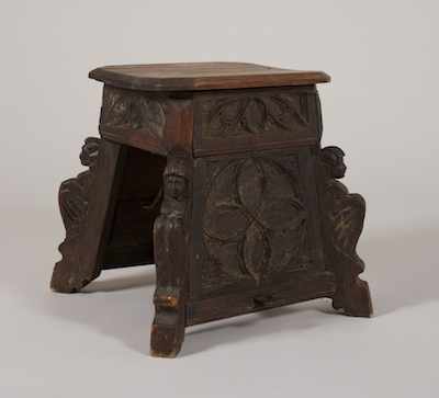 Appraisal: A Carved Oak Gothic Revival Style Stool Darkly stained oak