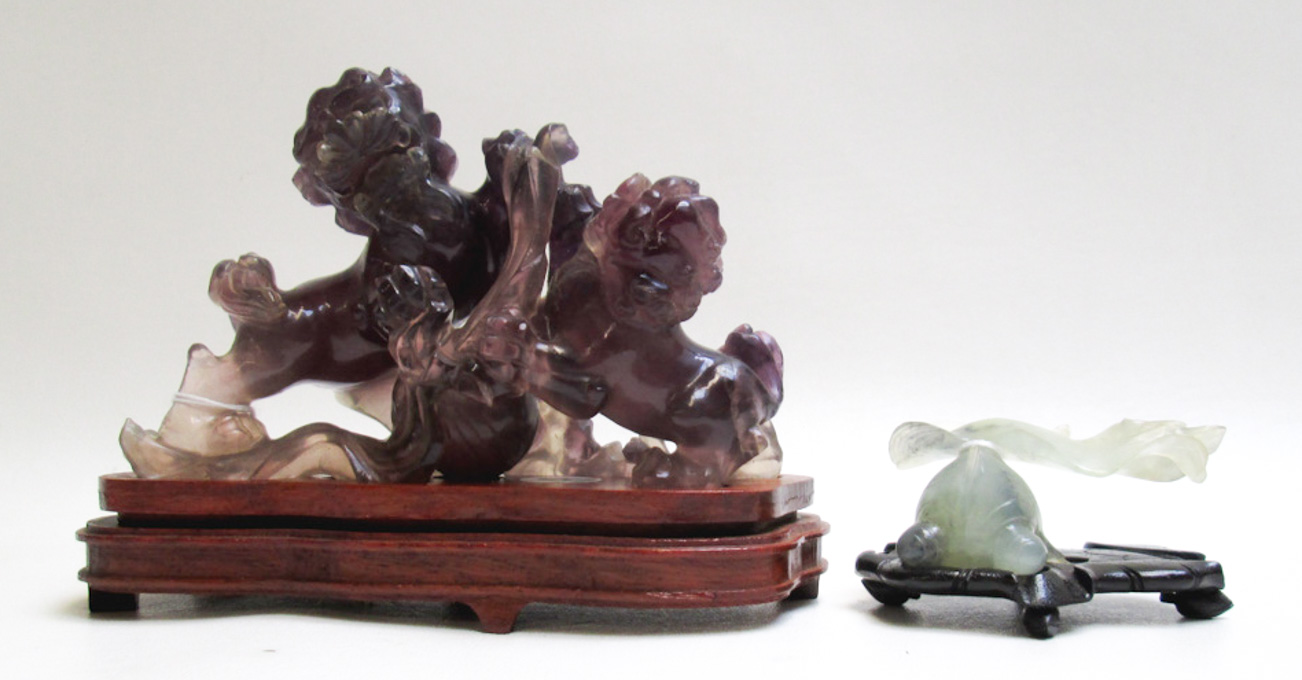 Appraisal: TWO CHINESE CARVED QUARTZ FIGURINES fitted on conforming hardwood plinths