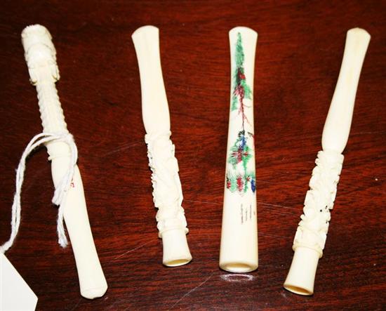 Appraisal: Four carved ivory cigarette holders three carved in a dragon