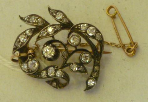 Appraisal: A VICTORIAN DIAMOND BROOCH modelled as a foliate scroll set