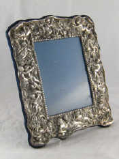 Appraisal: A Britannia silver photo frame heavily embossed with putti x